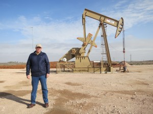 Tommy Taylor near a pumpjack outside Midland, TX.  Photo by Mose Buchele